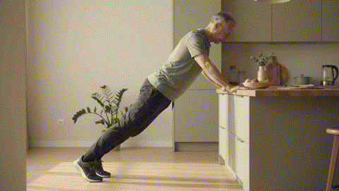 Fitness category avatar demonstrating a controlled incline push-up on a sturdy counter.